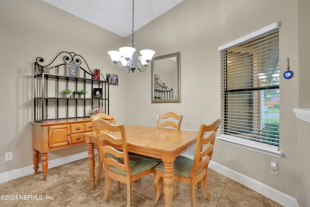 dining room with lofted ceiling and a notable chandelier