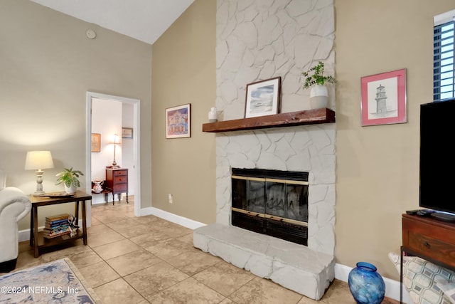 tiled living room featuring a fireplace and high vaulted ceiling