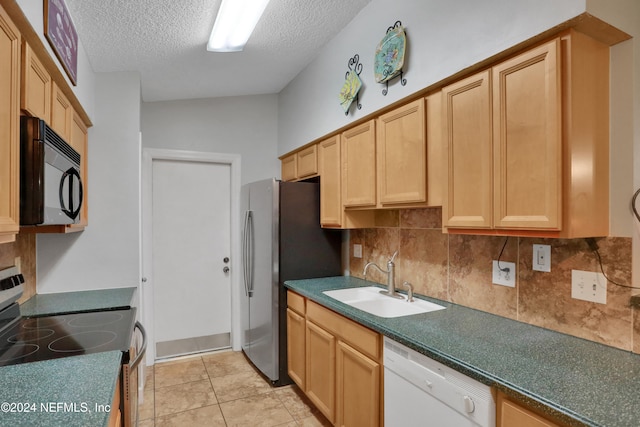 kitchen with sink, backsplash, stove, white dishwasher, and a textured ceiling