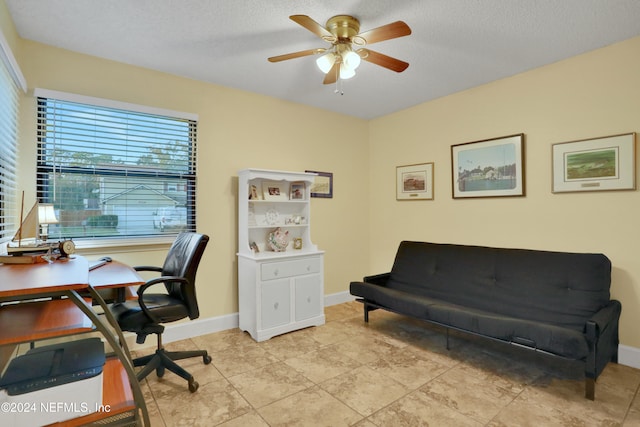 office featuring ceiling fan, light tile patterned floors, and a textured ceiling