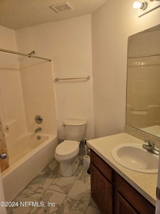 full bathroom featuring toilet, sink, shower / tub combination, and a textured ceiling