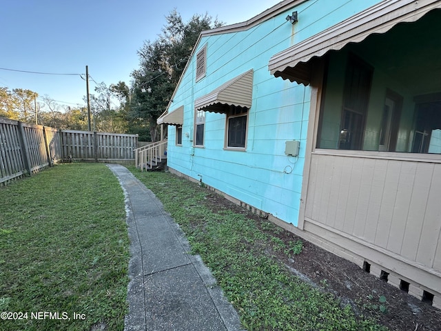 view of side of home featuring a lawn