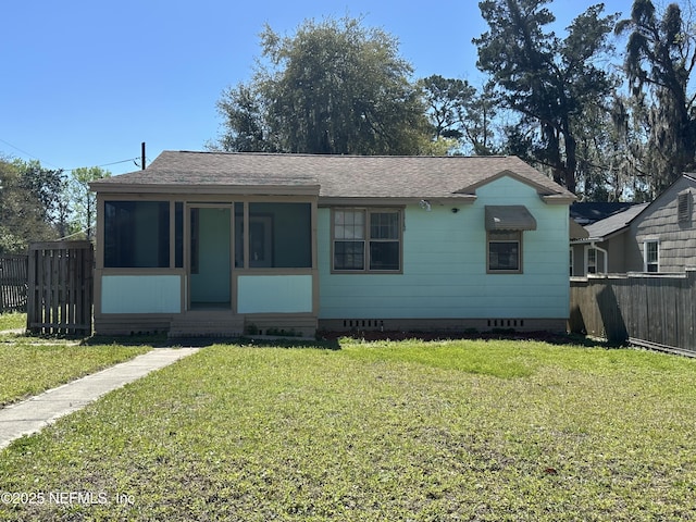 bungalow-style house with crawl space, a sunroom, a front lawn, and fence