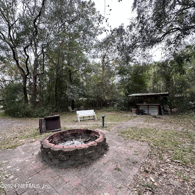 view of yard with a fire pit