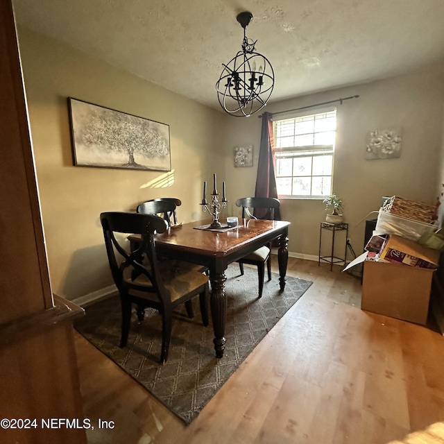 dining room featuring hardwood / wood-style flooring and a chandelier