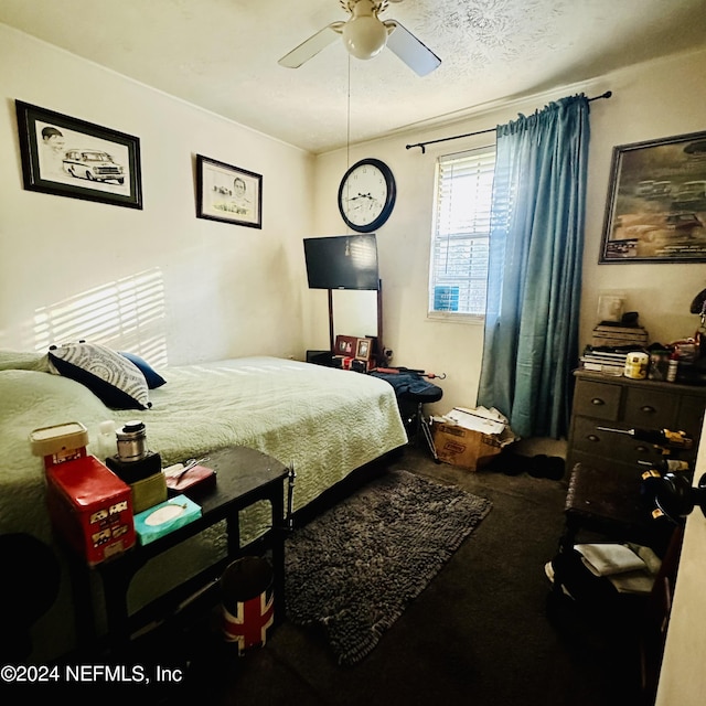 bedroom with ceiling fan, carpet, and a textured ceiling