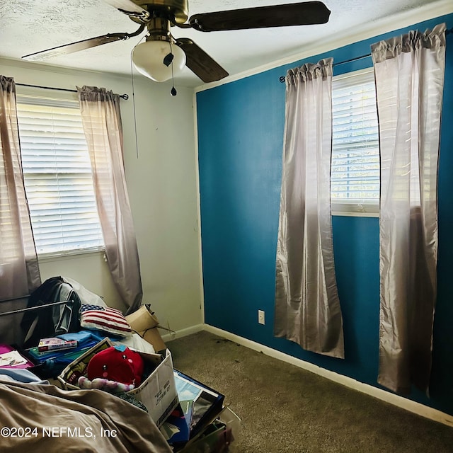 bedroom featuring a textured ceiling, carpet floors, and ceiling fan