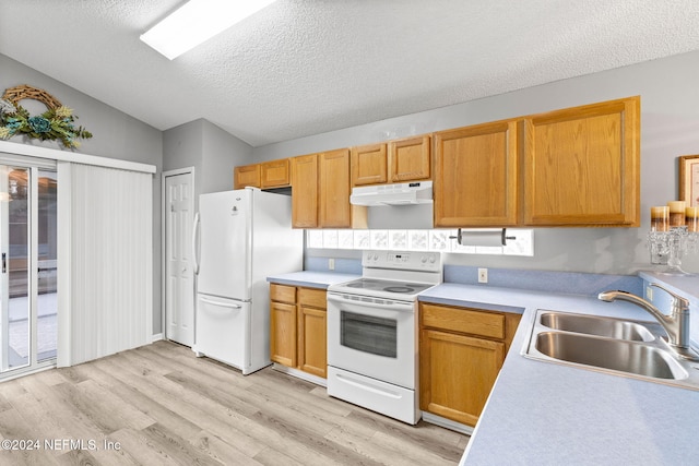 kitchen with sink, light hardwood / wood-style floors, vaulted ceiling, a textured ceiling, and white appliances