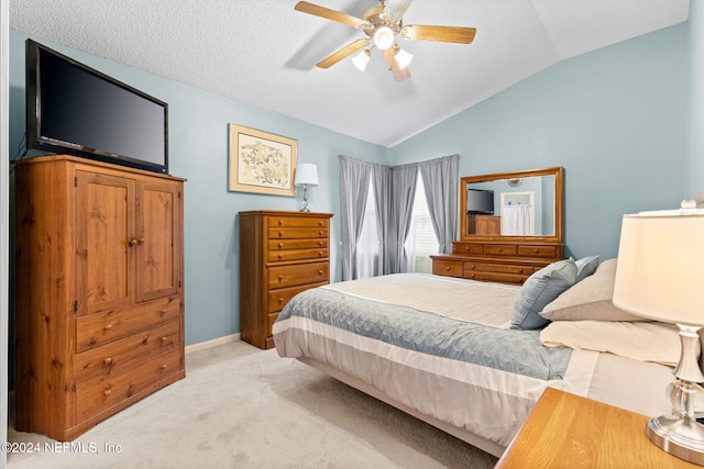 carpeted bedroom with ceiling fan and lofted ceiling