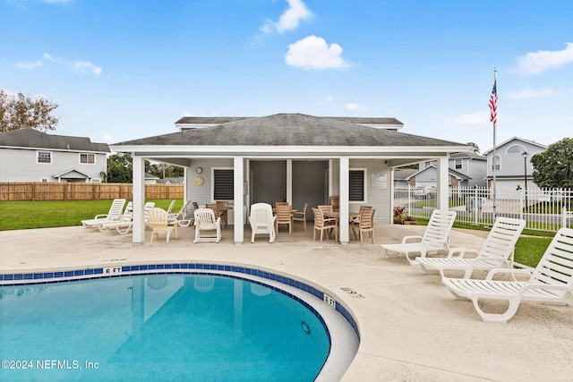 rear view of house with a patio area and a community pool