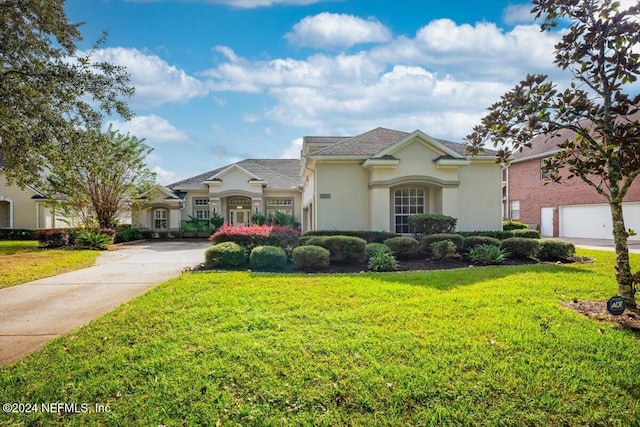 view of front of property with a garage and a front yard