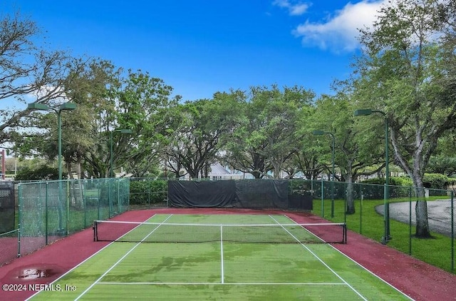 view of tennis court with basketball hoop