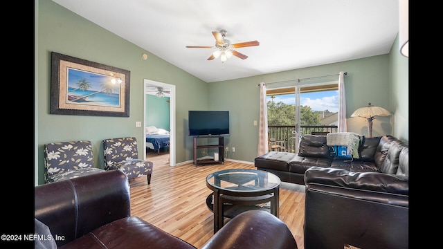 living room with ceiling fan, hardwood / wood-style floors, and vaulted ceiling