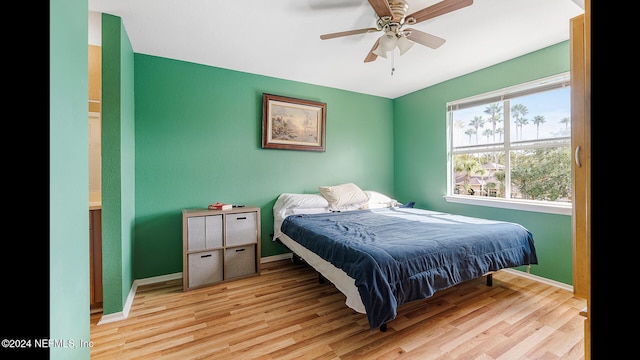 bedroom featuring light wood-type flooring and ceiling fan