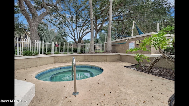 view of swimming pool with a community hot tub