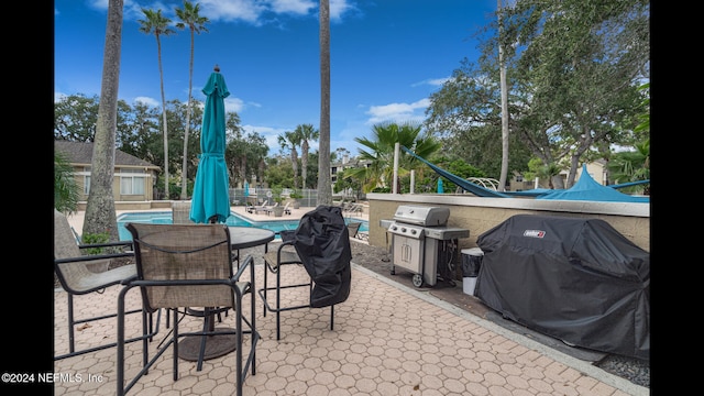 view of patio featuring a grill