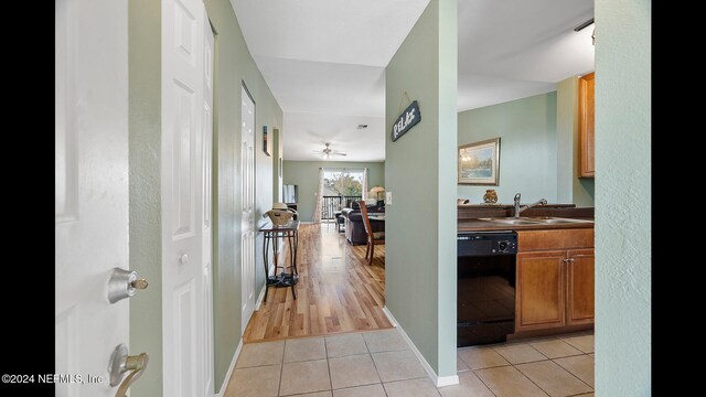 hallway with light hardwood / wood-style floors and sink