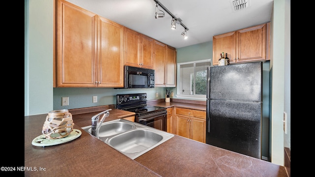 kitchen featuring sink, rail lighting, and black appliances