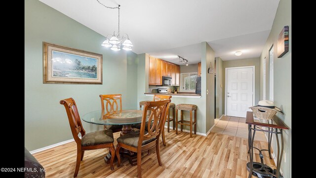 19 Arbor Club Dr Unit 317, Ponte Vedra Beach, FL 32082 - dining room featuring light wood-style floors, baseboards, and a chandelier