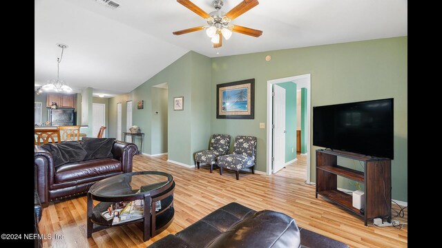 19 Arbor Club Dr Unit 317, Ponte Vedra Beach, FL 32082 - living area with vaulted ceiling, a ceiling fan, light wood-style floors, baseboards, and a chandelier