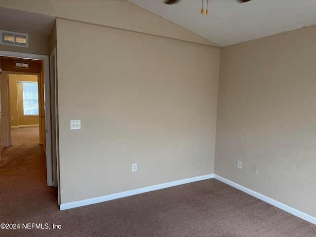 carpeted spare room with ceiling fan and lofted ceiling