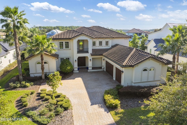 mediterranean / spanish-style home with a garage