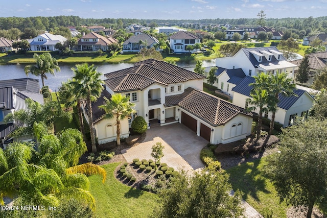 birds eye view of property with a water view