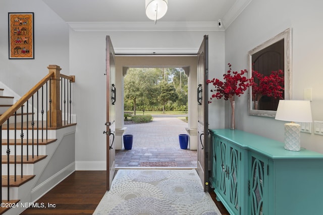 foyer featuring dark wood-type flooring and ornamental molding