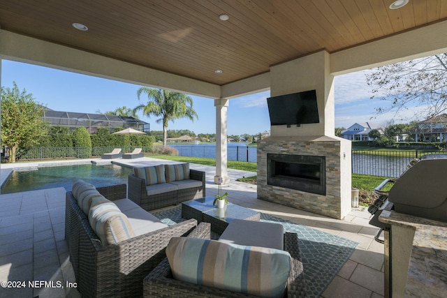 view of patio / terrace with an outdoor living space with a fireplace and a fenced in pool