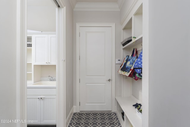 mudroom featuring ornamental molding and sink