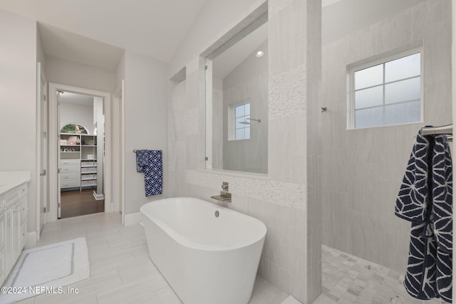 bathroom with separate shower and tub, vanity, a healthy amount of sunlight, and lofted ceiling