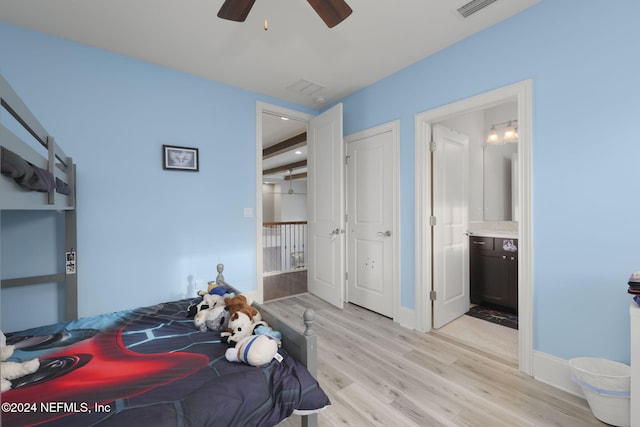 bedroom featuring ceiling fan, light hardwood / wood-style flooring, and ensuite bathroom