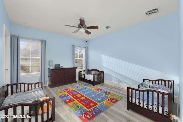 bedroom featuring ceiling fan and light hardwood / wood-style flooring