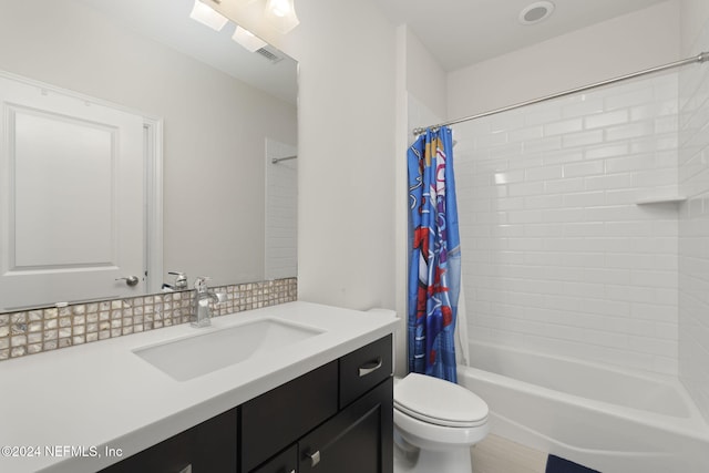 full bathroom with shower / tub combo with curtain, vanity, and toilet