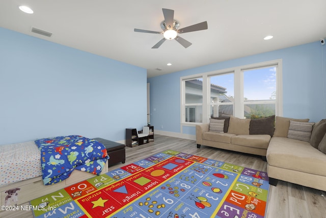 living room with hardwood / wood-style flooring and ceiling fan