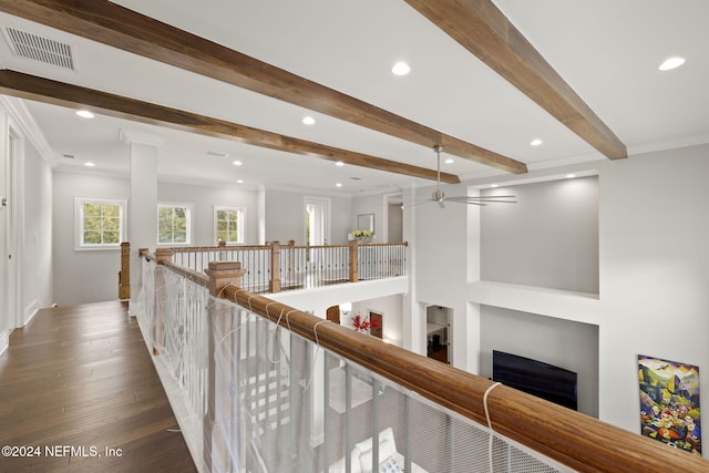 hallway with beamed ceiling, hardwood / wood-style floors, and ornamental molding