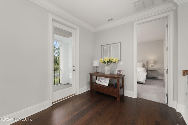 entrance foyer with dark hardwood / wood-style floors and ornamental molding