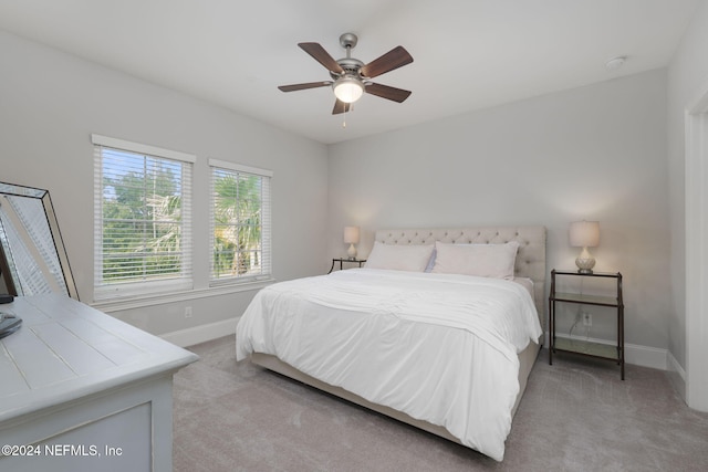 bedroom with ceiling fan and light colored carpet