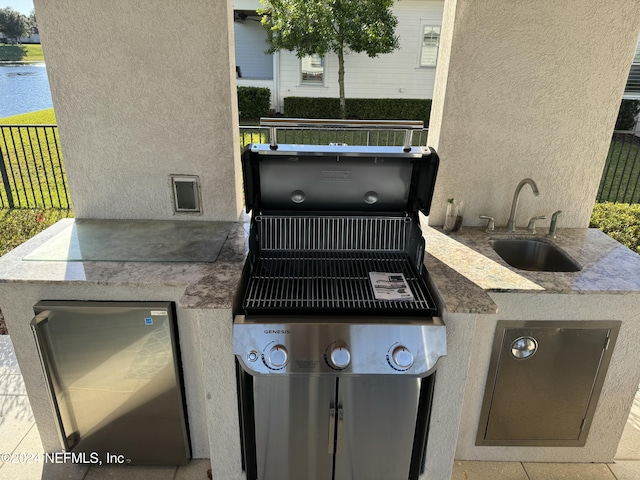 view of patio / terrace with area for grilling and sink