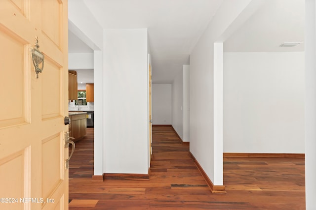 hallway with dark hardwood / wood-style floors