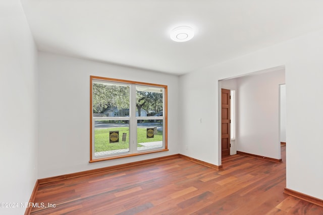 unfurnished room featuring dark wood-type flooring