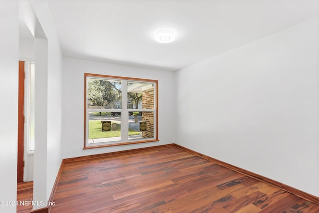 unfurnished room with dark hardwood / wood-style floors