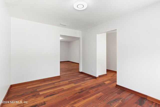 spare room featuring dark hardwood / wood-style floors