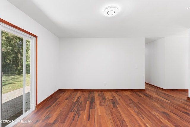 additional living space featuring dark wood-type flooring