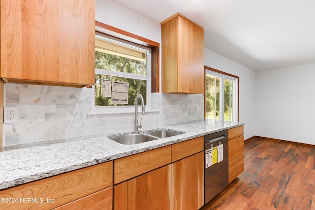 kitchen with sink, stainless steel dishwasher, light stone countertops, tasteful backsplash, and dark hardwood / wood-style flooring