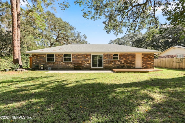 rear view of house with a yard and a patio area