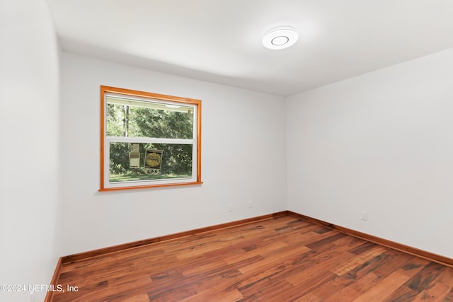 unfurnished room with hardwood / wood-style flooring