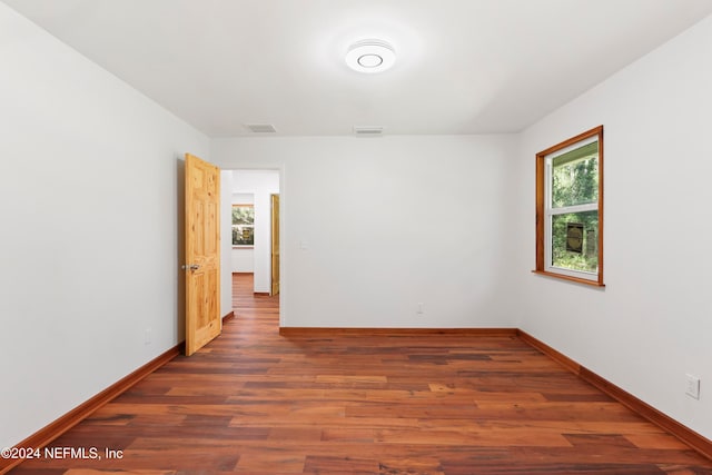 spare room featuring dark wood-type flooring