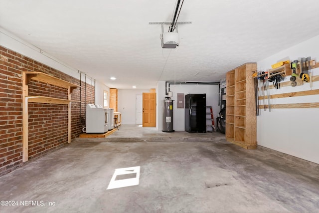 garage featuring black refrigerator, electric water heater, washer / clothes dryer, and a garage door opener