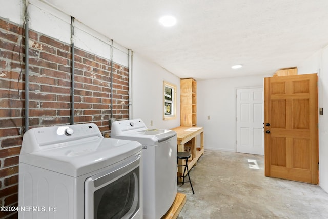 washroom featuring washing machine and dryer and a textured ceiling